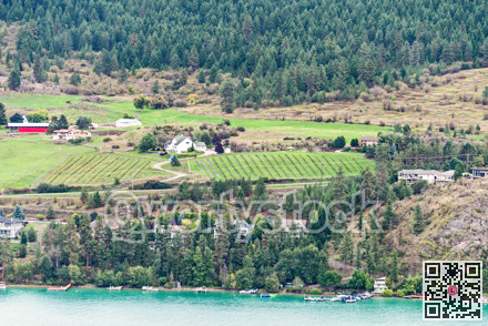 Waterfront land terrace with farm fields and residential houses built on it