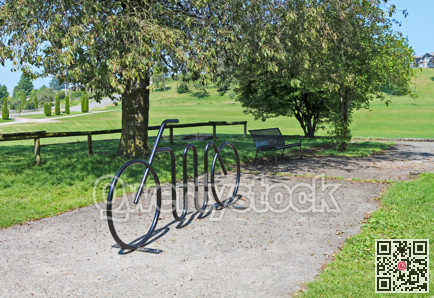 Bench in a park with artistic bike rack on a hot summer day