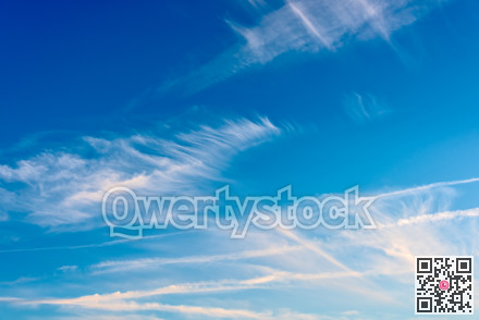 Feather clouds on deep blue sky background