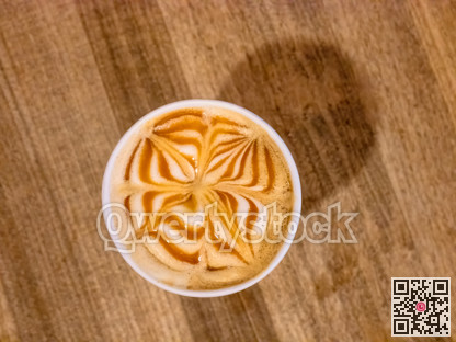 A cap of cappuccino with decorated caramel on the top