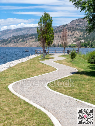 Winding trail leading to wooden sightseeing platform on the lake
