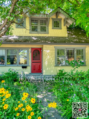 Old residential house in shades of trees on bright sunny day