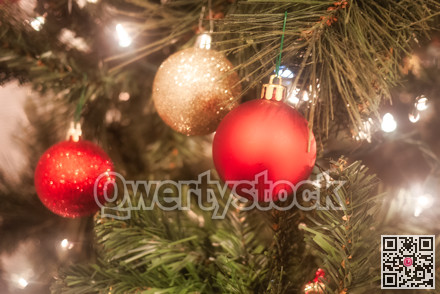 Halo of electtric lights and color balls decorating artificial Christmas tree