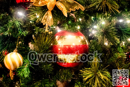 Halo of electtric lights and color balls decorating artificial Christmas tree
