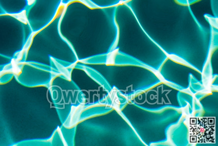Sunflecks on emerald water surface in a swiming pool