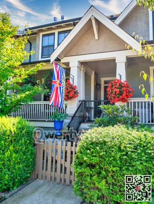 Porch of residential house with British Columbia flag at the entrance