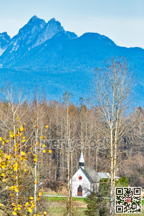 Small white church on autumn season in sunlight