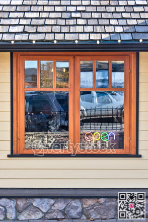 Street cafe window with colour light sign Open inside