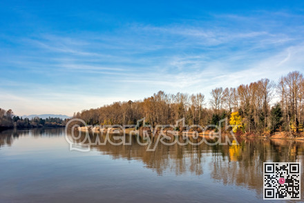 Autumn landscape with a river on blue sky background