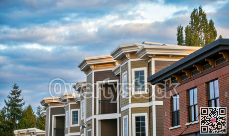 Top of residential building on cloudy sky background