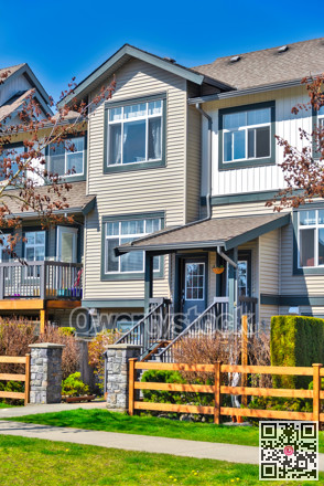 Residential townhouse entries with wooden fence in front