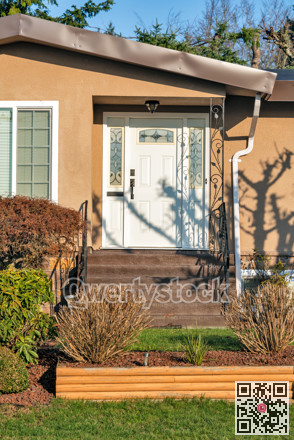 Main entrance of residential house with doorsteps on sunny day in winter.
