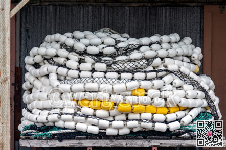 Trawler fishing net and floats stored on wooden pallet