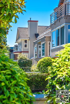 Front of houses with landscape yard on sunny day