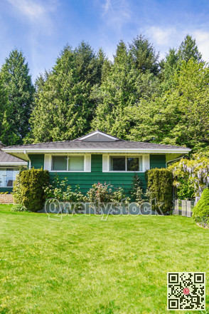 Family house on green trees and blue sky background