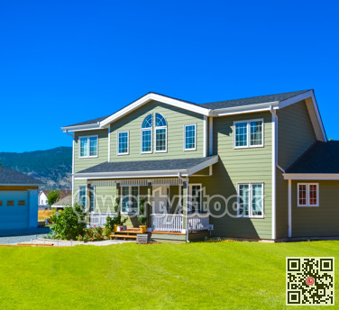 Big family house with pathway to the door in front and blue sky background