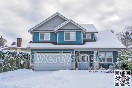 Family house with front yard in snow