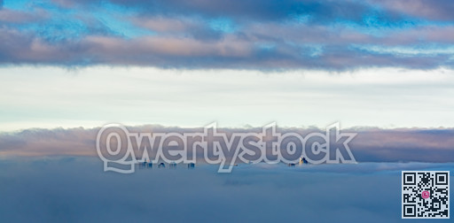 Sunrise view at Metrotown towers covered with the fog on cloudy sky background