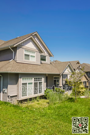 Suburban residential house with green lawn in front