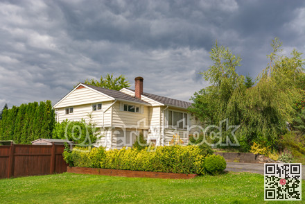 Old family house with green lawn in front