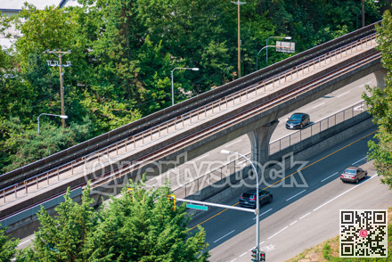 Cityscape. Fragment of four lane road with skytrain path over