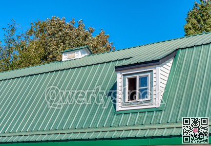 The window on green roof of a farm barn