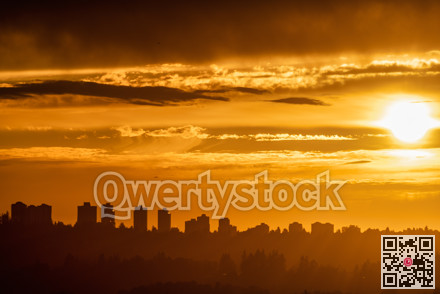 Cityscape on sunset cloudy sky background closer to the night