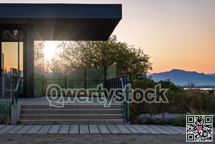 Closed beach cafe in sunset light rays