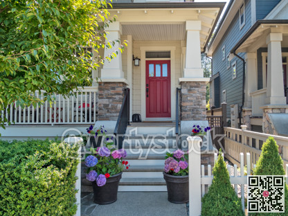Porch and entrance of a nice residential house with two flower pots