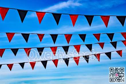 Coloured flying pennons on blue sky background
