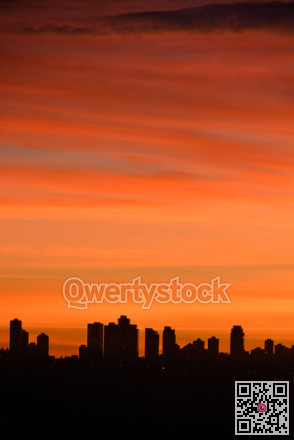 silhouette of residential buildings on sunset sky background