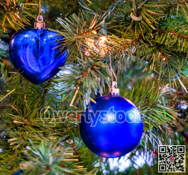 Blue heart and blue bauble on Christmas tree brenches
