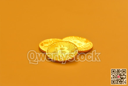 Three yellow bitcoin beans laying on flat surface.