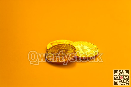 Three yellow bitcoin beans laying on flat surface