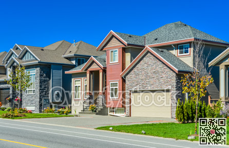 New family house with concrete driveway and asphalt road in front.