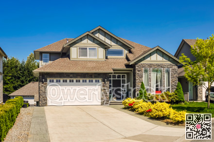 Luxury residential house with concrete driveway and wide garage gate.