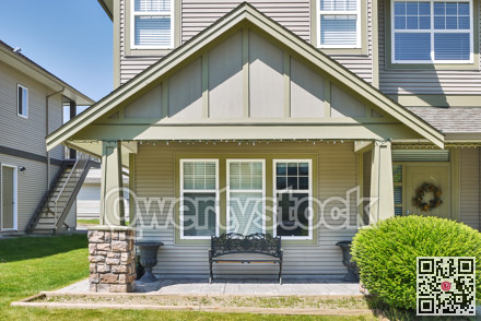 Facade of family house with casted bench at the window beside the entrance
