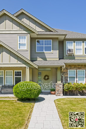 Entrance of family house with concrete pathway over green lawn