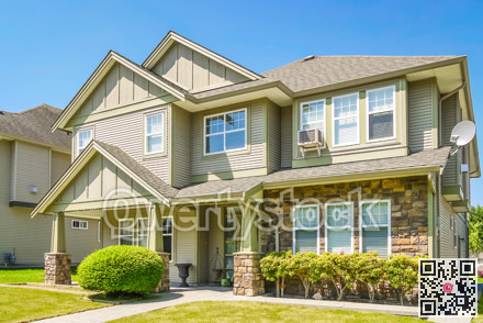 Luxury residential house with concrete pathway over front yard.