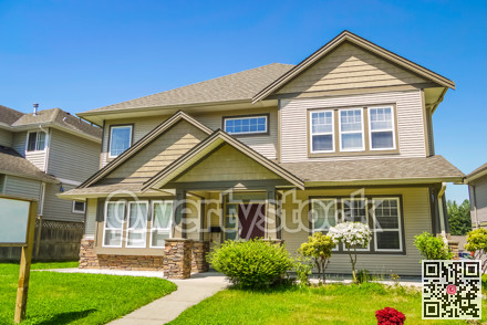 Family house with concrete pathway over the front yard