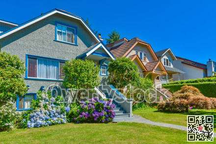 Residential house with the pathway over front yard lawn on blue sky background
