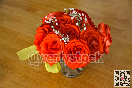 Beautiful bouquet of red roses on a wooden table