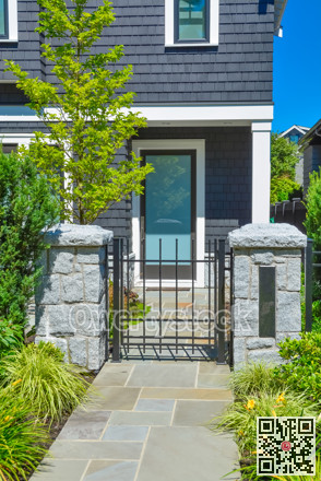 Stone tile paved pathway leading to the entrance door