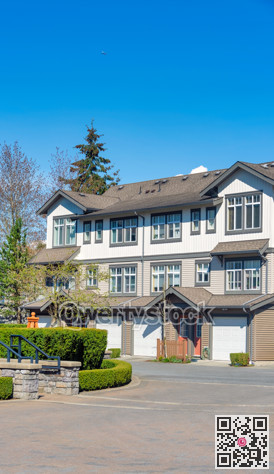 Residential townhouses building with a flying plane in the sky