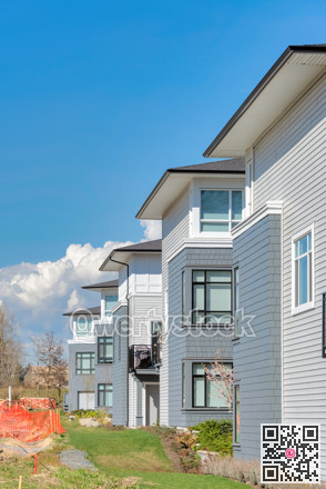 Brand new residential townhouses on blue sky background