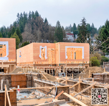 Wooden frame of new house with concrete filled fundation in front