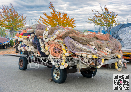 Trawler fishing net and floats stored on auto trailer