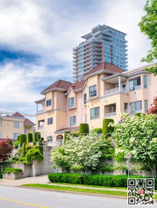 Italian style low-rise residential building with decorative trees in front