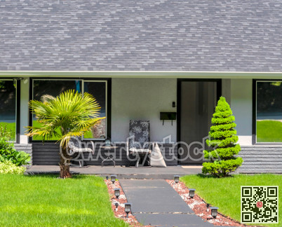 Main entrance of residential house with concrete pathway on bright sunny day