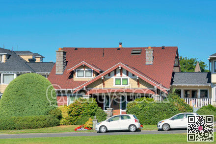 Luxury residential house with two small cars parked in front